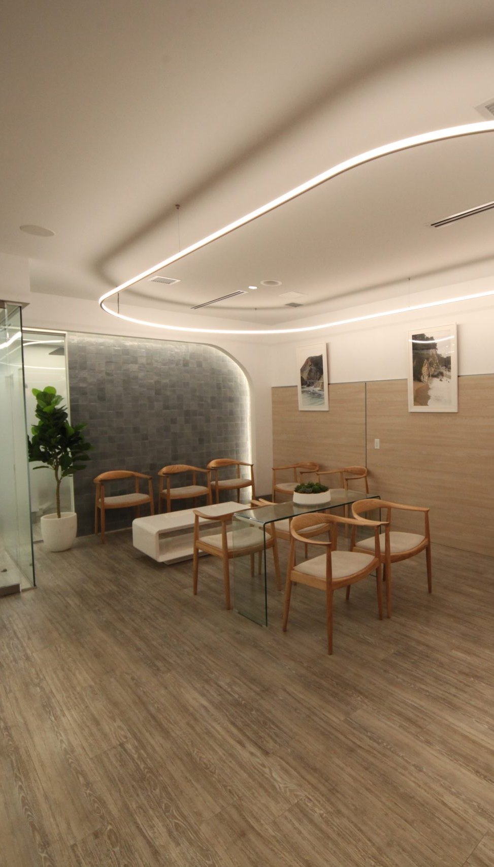 The waiting room at City Square Dental Center: oak chairs under a ring of light